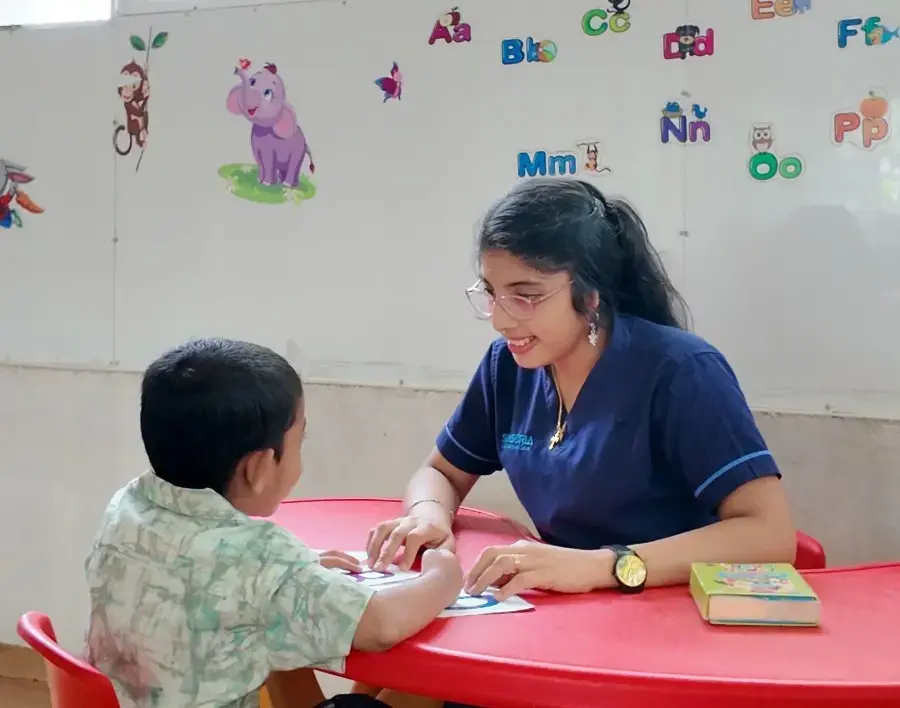 therapist in a session with the child at the child development center in kerala