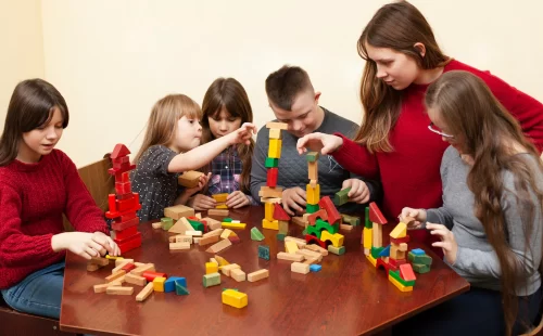 children-with-down-syndrome-playing-with-toys_23-2148464595