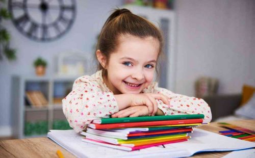 smiling-girl-studying-home (1)