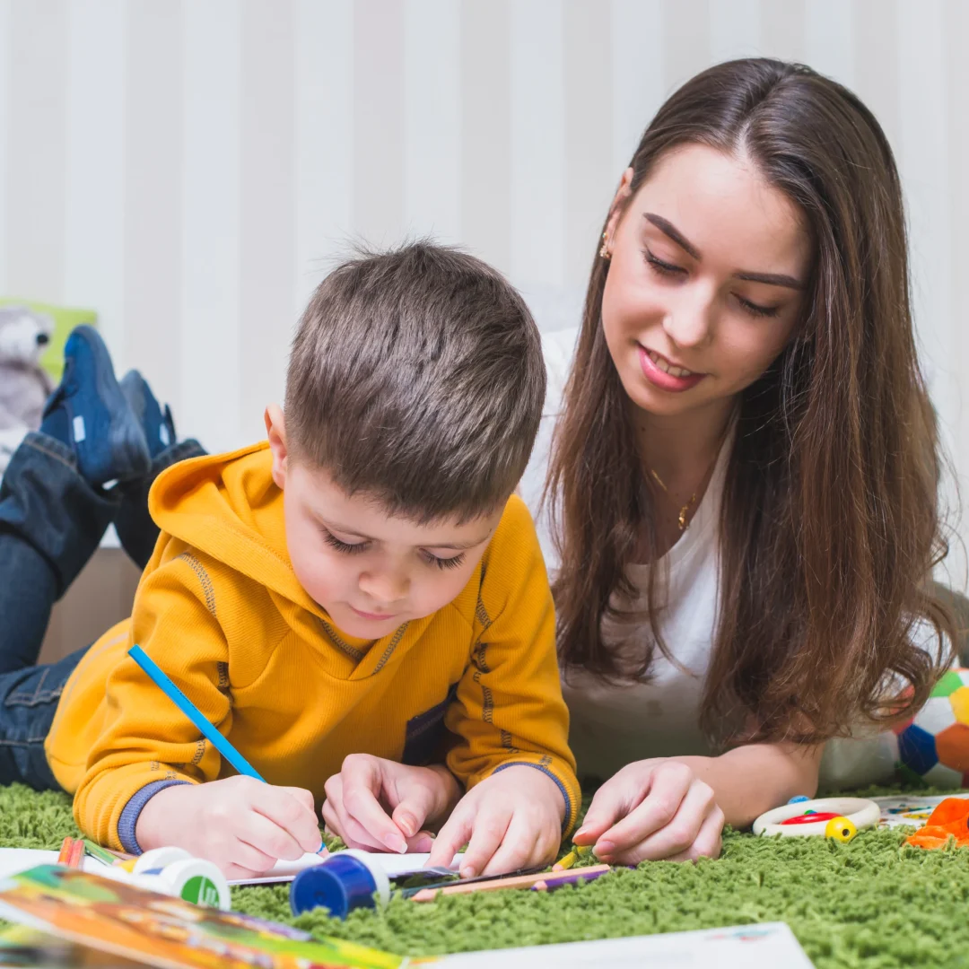 One-on-One Learning Support Teacher helping young boy with a drawing during a learning activity.